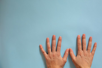 Hand identification. Hygiene during an epidemic. Female hands on a blue background.