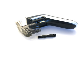 Hairdressing machine for cutting hair isolated on a white background. Hair clipper and nozzle. Set for cutting hair. Electric machine for a beauty salon. Tool for male hair cutting.