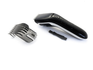 Hairdressing machine for cutting hair isolated on a white background. Hair clipper and nozzle. Set for cutting hair. Electric machine for a beauty salon. Tool for male hair cutting.