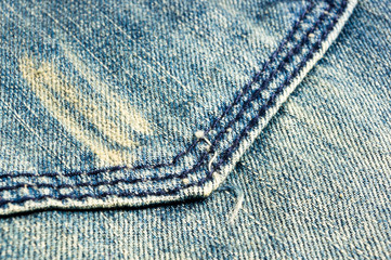 clothing items blue stonewashed faded jeans cotton fabric texture with seams, clasps, buttons and...