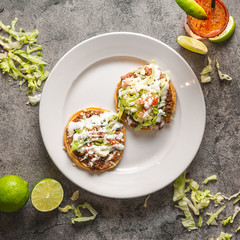 Beautifully plated mexican two taco plate with drink