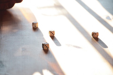 Game dice on sunlit table
