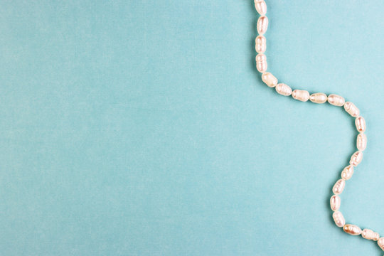 women's accessories made of pearls on a blue background, top view