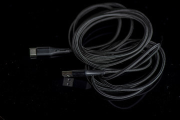 USB Type-C cable. Photographed close-up against a dark background.