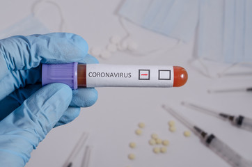 Obraz premium Negative blood test for coronavirus, surgical medical mask and medication on a white background, pneumonia and bronchitis concept. Viral infection.