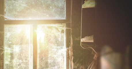 bright ray of sun illuminate room through old window of village house