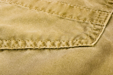 clothing items stonewashed cotton fabric texture with seams, clasps, buttons and rivets, macro