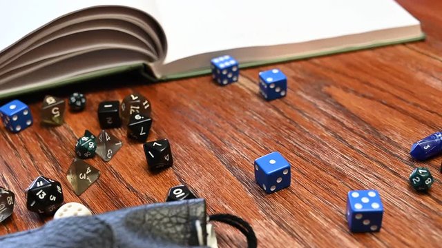 Slow motion hand rolling a several d6 dice