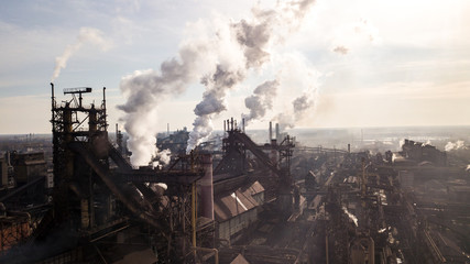 Fototapeta na wymiar Steel ecology metallurgical iron plant smokes from pollution of industry pipes. View from the drone.