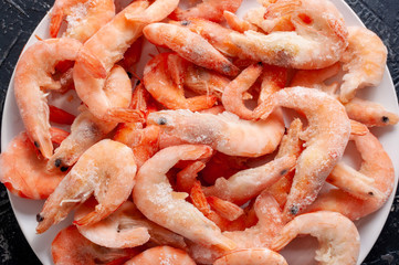 Frozen king prawns on a white plate