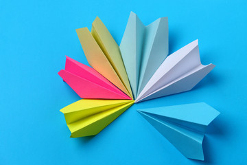 Paper airplanes, teamwork metaphor, on blue background