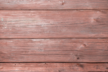 Pink old weathered wooden surface of the log walls of the farmhouse. Wooden background texture for your design, blank template