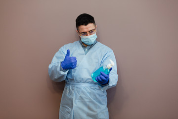 Studio portrait of young man wearing face mask looking at camera, close up isolated on purple background