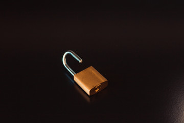 Padlock with key isolated on black background