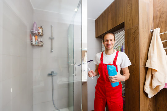 Male Scrubbing A Home Bathroom Gray Tile Shower Wall