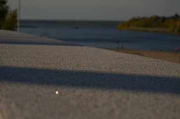 Obraz premium embankment of light stone close-up against the background of the river