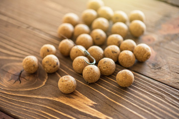 Carp baits on a wooden background.