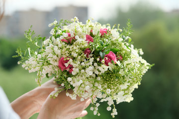 Beautiful fresh bouquet in woman hand. Floristry, work of florist