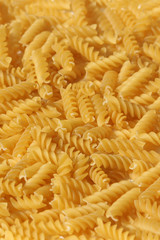A large quantity of pasta. the pasta is solid, long, thick, corkscrew or spiral shaped. This shape of pasta is known as Fusilli.