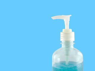 closeup hand sanitizer in transparent bottle with pump lid isolated on blue