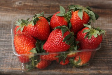 Delicious juicy strawberries on a wooden table
