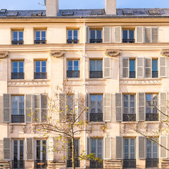 Paris, typical facade in the Marais, detail of the windows