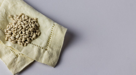 Beans on a cloth napkin. White background. Top view