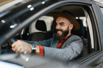 Man checks the interior of truck in car dealership