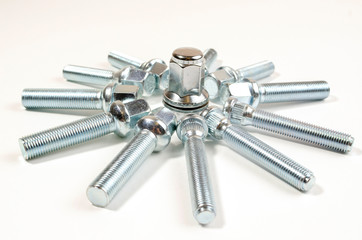 nuts and studs for a car in an abstract figure on a table
