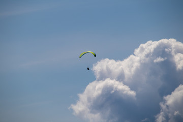 Image of interesting cloud formations with paraglider in summer in the Austrian Alps,