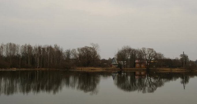 Small pond and old houses in the suburbs near Leningradskoye Shosse