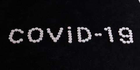 Word COVID-19 made from tablets. Coronavirus concept.