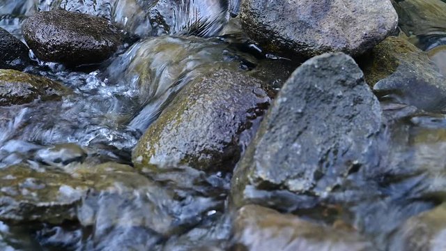 Close up view of water flowing over rocks in river