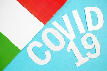 Covid - 19, 2019-nCoV virus concept. Coronavirus word from letters and Italian flag on blue...