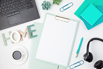 Top view of office desk. Table with laptop, conference speakerphone and office supplies. Flat lay home office workspace, remote work, distant learning, video conference, calls