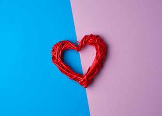 red wicker decorative heart on a blue lilac background
