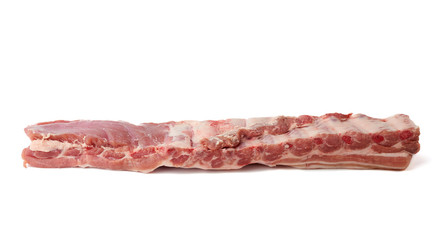 strip of pork meat on ribs with layers of fat isolated on a white background