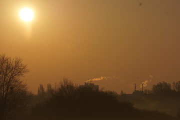 Misty sunrise with distant houses