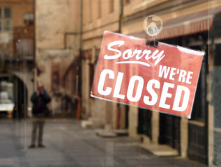 "Sorry we're closed" sign on the cafe door