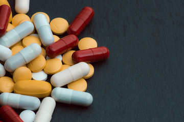 Different sorts of medicaments on black slate