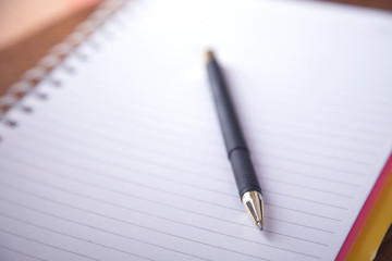 pen with notepad on the table