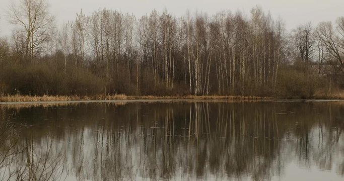 Small pond and old houses in the suburbs near Leningradskoye Shosse