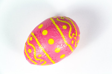 Chocolate egg in pink paper for easter