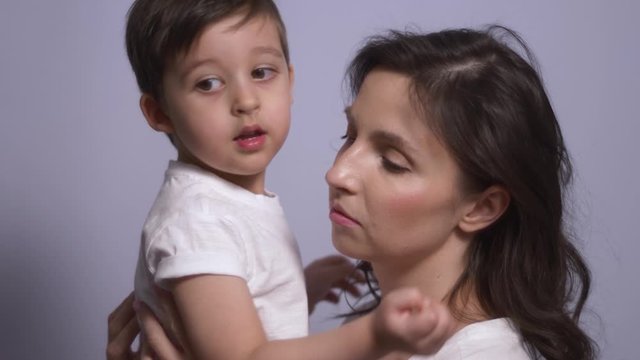 mother and son in white t-shirts on a white background