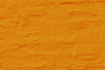 Saffron plastered brick wall texture.
