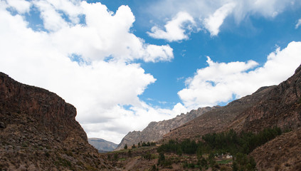 Colca Canyon mountains in Peru with a blue cloud sky. Peruvian Andes