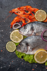 Fresh dorado fishes and shrimp prepared to cooking
