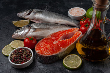 Fresh salmon and seabass fishes on bord