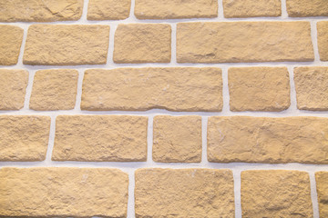 The background is made of artificial sand-colored stone with a large rectangular shape. Backgrounds, textures, and design.