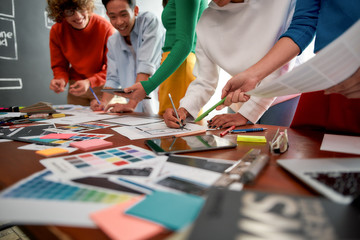 Graphic design team. Cropped photo of creative people prototyping new web site design for a client...